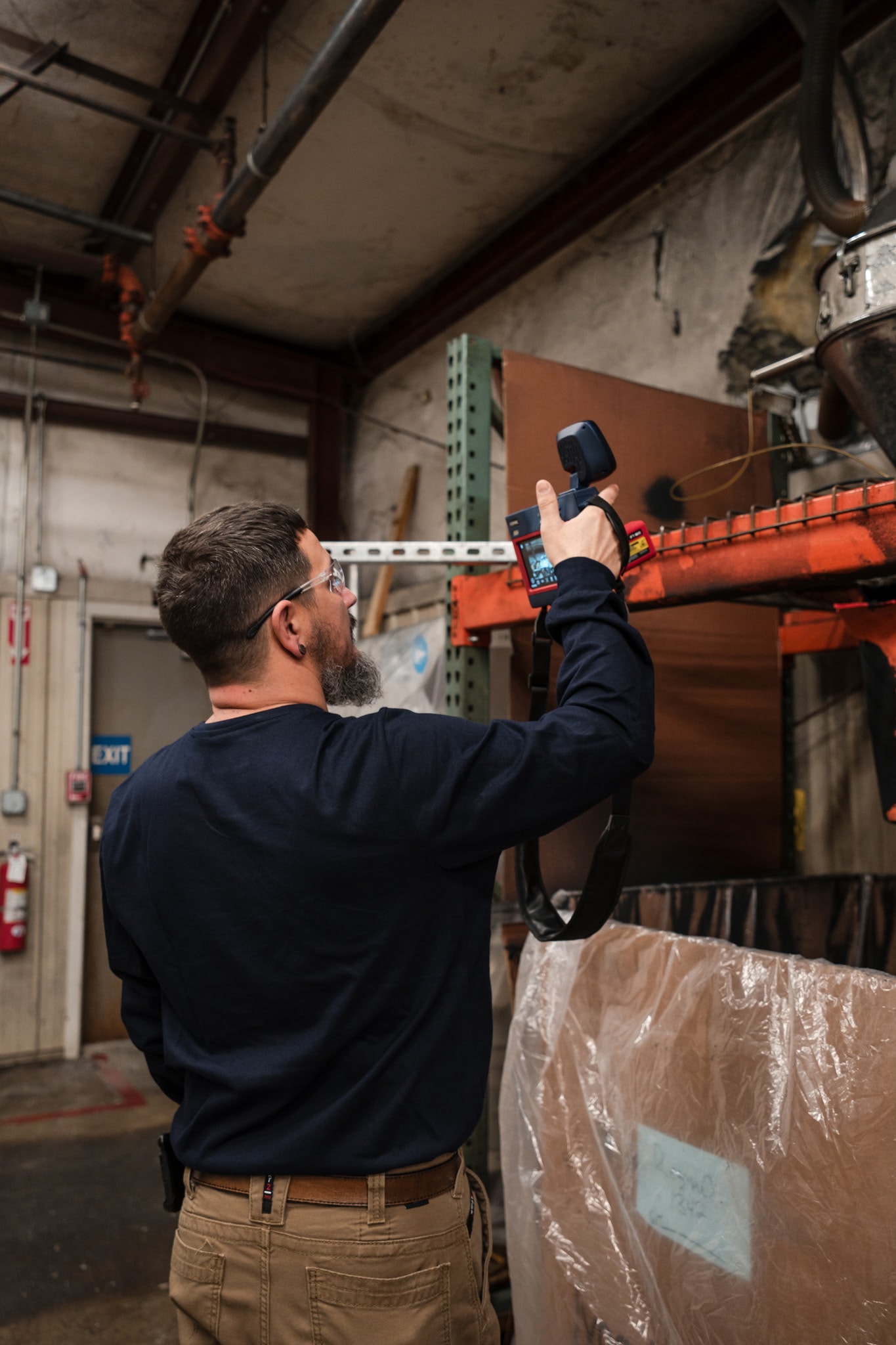 Industrial reliability engineer performing predictive maintenance inspection